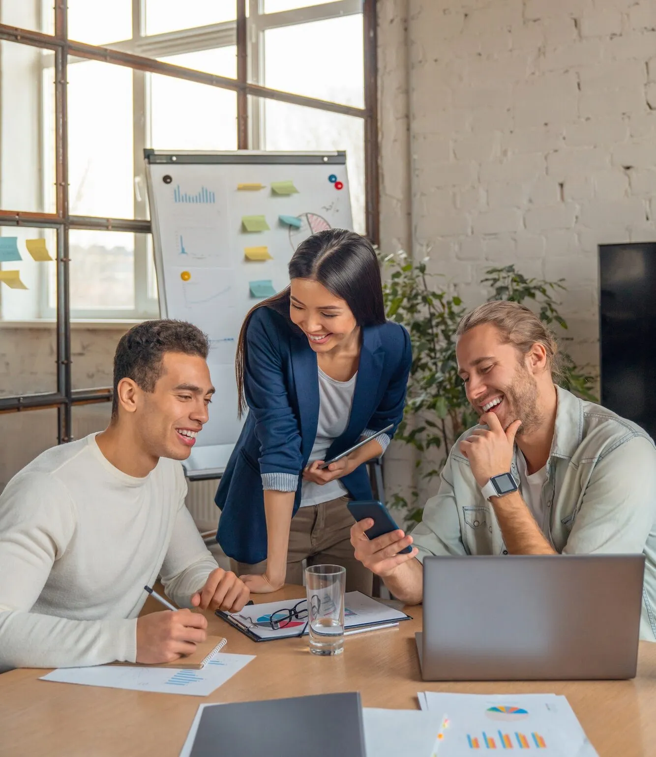 Group of multiracial business people with smartphone and laptop having a meeting in an office